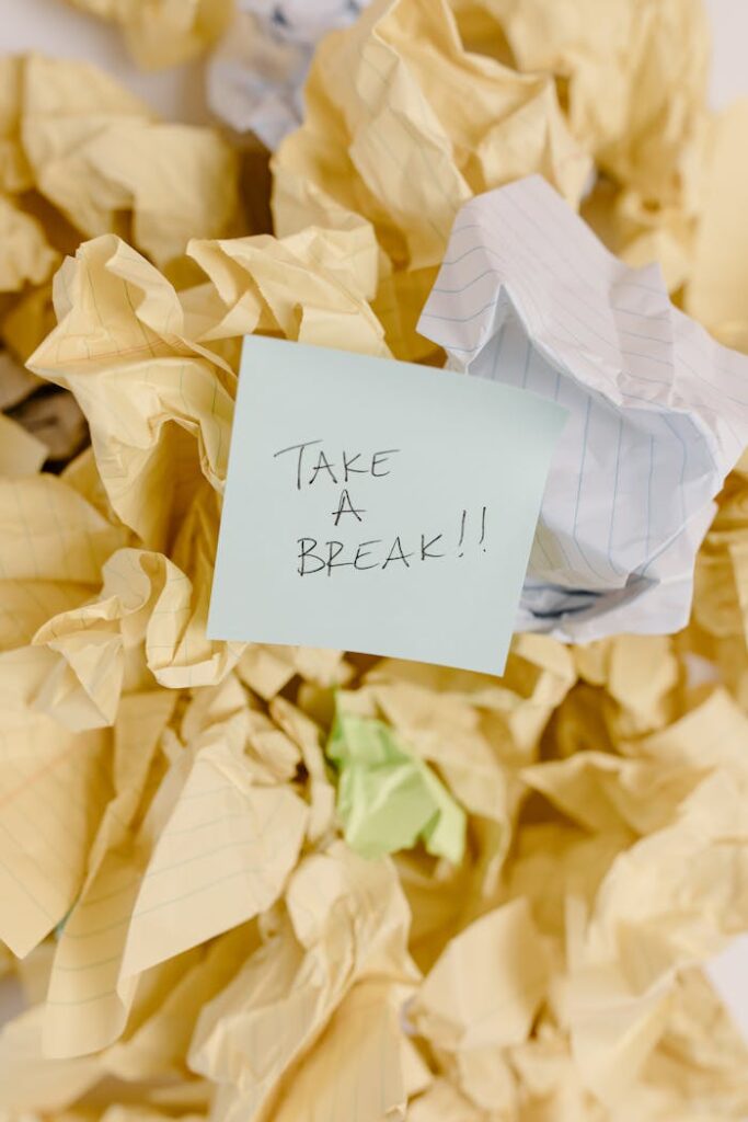 Sticky note with 'Take a Break' on crumpled paper background.